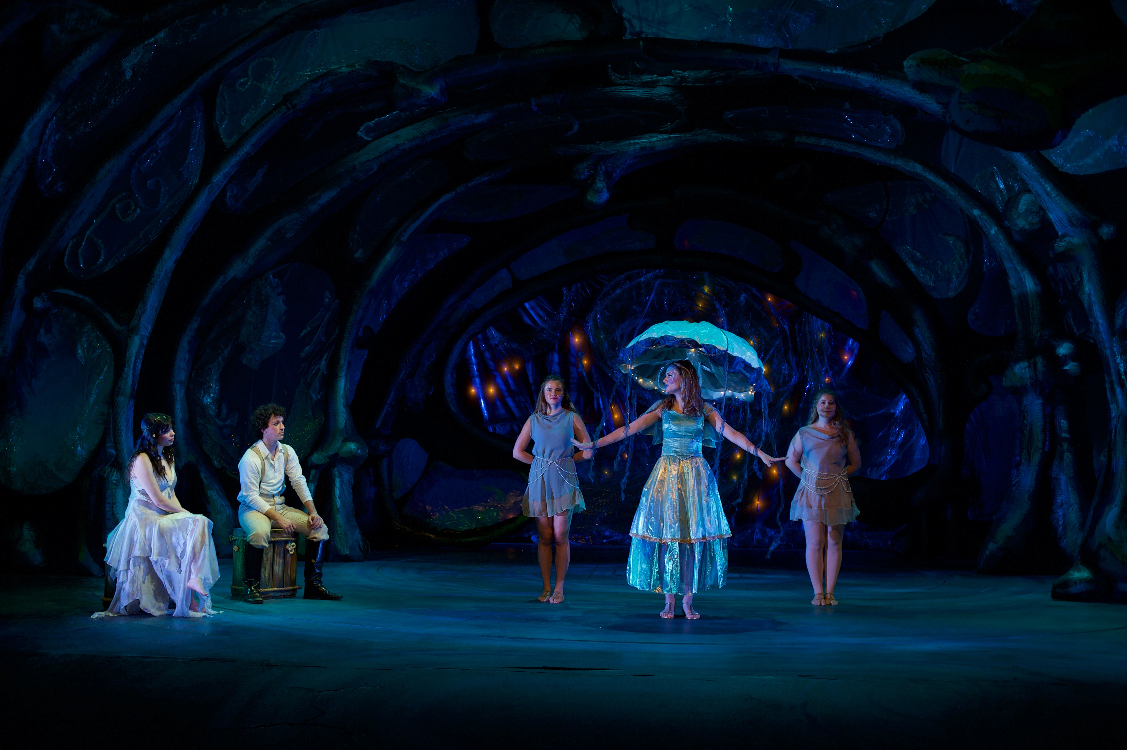 Isabella Biricik in The Tempest - blue-lit stage with ensemble